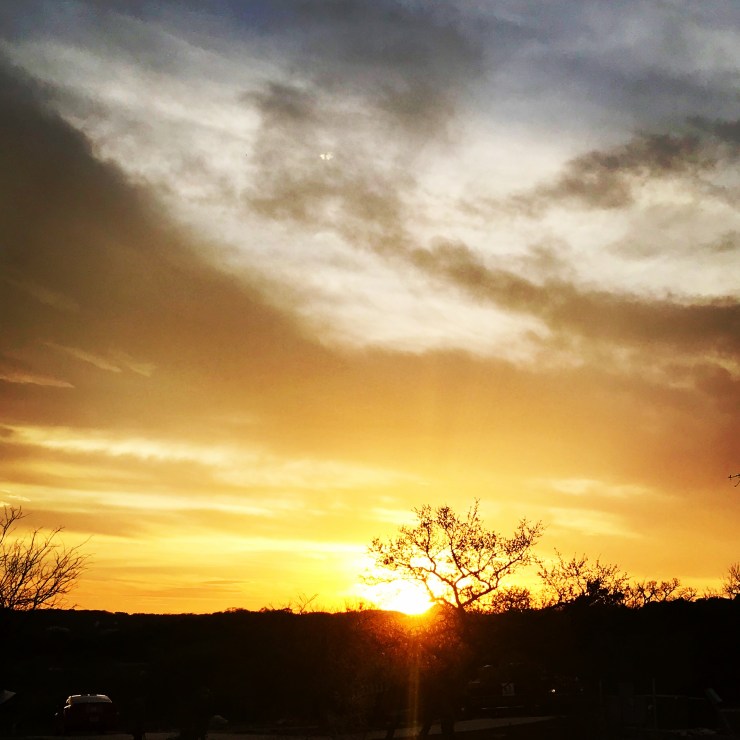 a picture of a yellow sunset and the setting sun